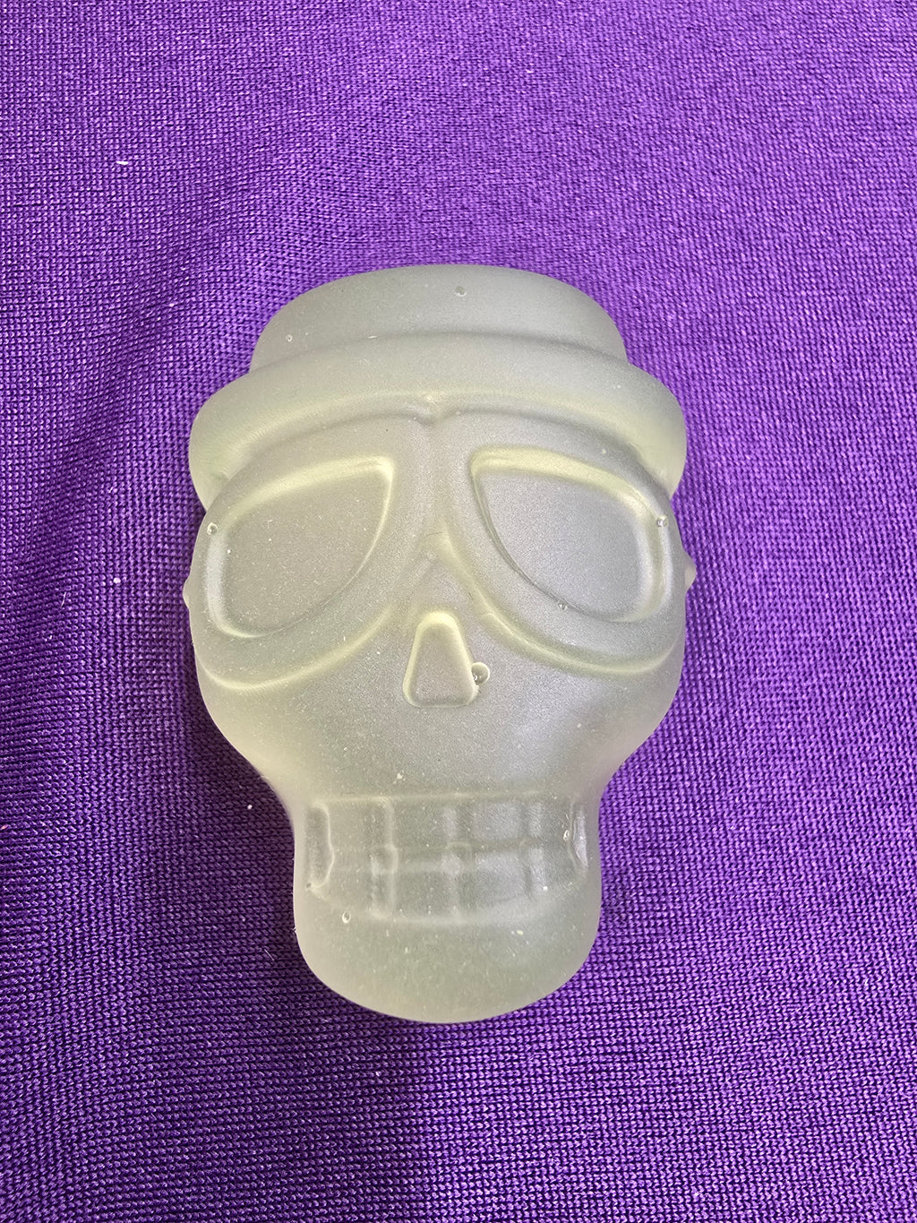 A translucent frosted skull magnet.